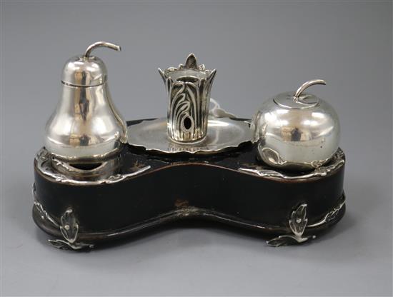 A Victorian novelty silver mounted ebonised inkstand, modelled as an apple & pear and rustic taperstick,